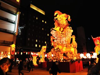 Shinchi Bridge, which connects the city with Chinatown, is bustling with people admiring giant monuments of light