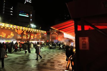 <p>Rows of food stalls standing in front of the lion dance stage</p>