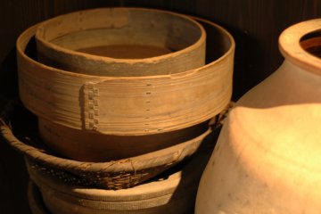 <p>Some old kitchen implements include sifters, baskets, and jars.</p>