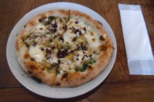 A white sauce-based pizza with chives, shiitake mushrooms and a layer of spinach, also only available to eat in