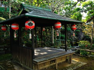 A small pavillion stands beside the pond