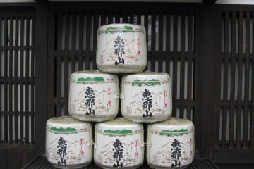 Large casks of Ena-san sake sit outside Hazama.