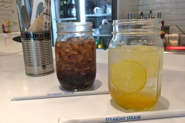 <p>Homemade Honey Lemonade and Coca-Cola served in mason jars</p>