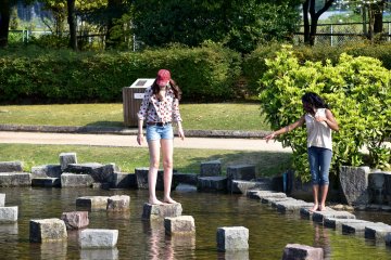 <p>Foreign visitors playing in the pond. Actually, they were trying to pick up a football they dropped in the pond.</p>