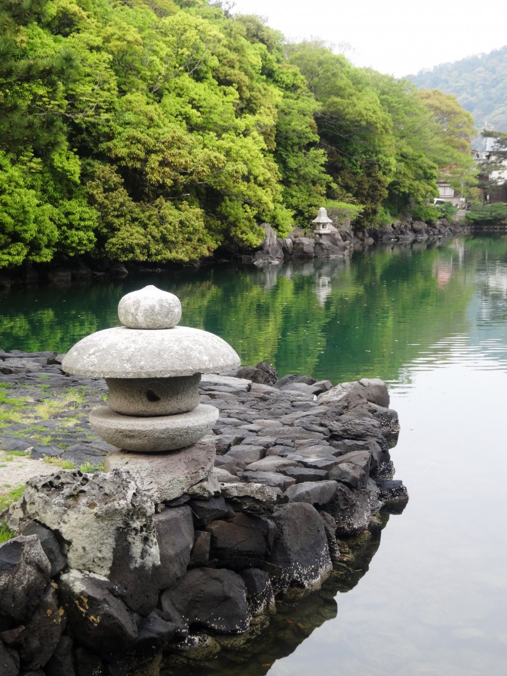 A lantern overlooks the tidal Myojin Pond at the foot of Hagi&#39;s Mt Kasa