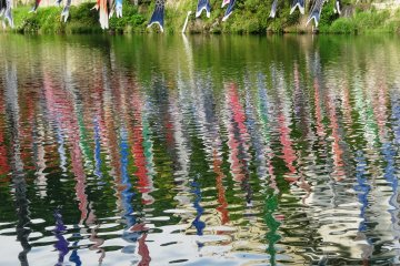 <p>The streamers are reflected in the water</p>