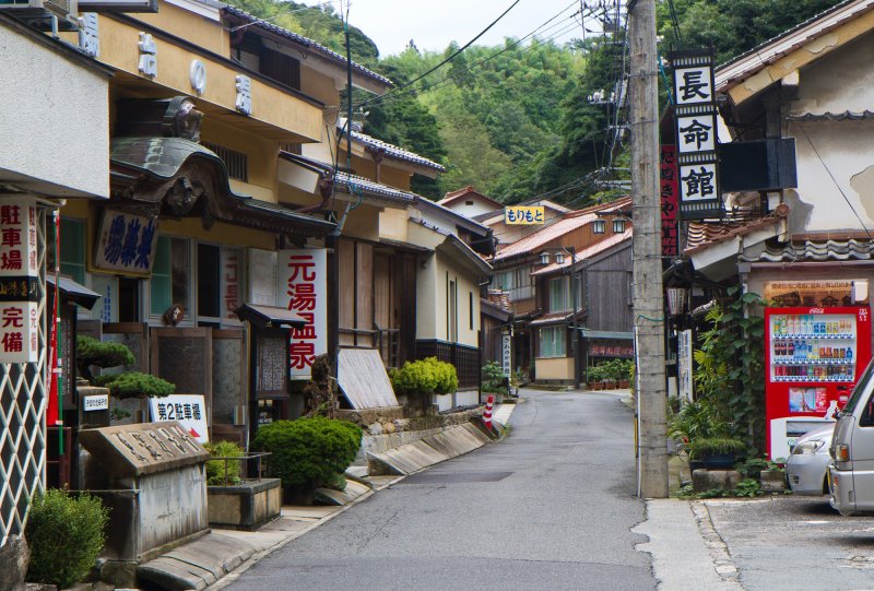 <p>Moto-yu, on the left, is one of the several bathhouses along the single-lane road of Yunotsu</p>