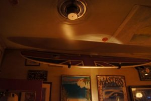 The walls and ceiling are adorned with surf memorabilia