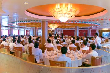 <p>Waiters meeting prior to evening service in Fantasia Restaurant</p>