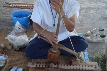 A volunteer demonstrates fire-make methods used by the Yayoi people