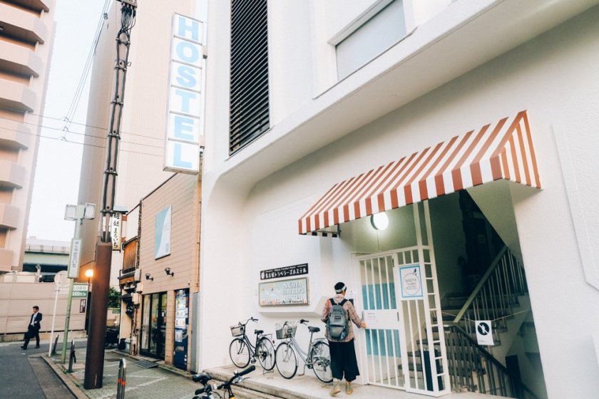 The exterior of Nagoya Travellers. Spot the big signage of "Hostel" and usually there are lots of bicycles parked outside the building.