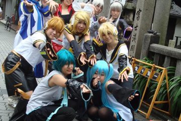 A group of Vocaloid cosplayers pose together before the parade
