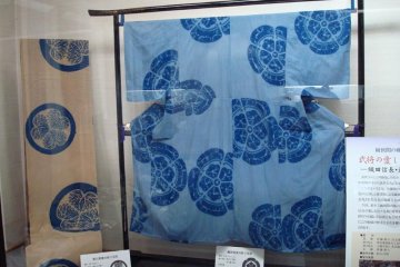 Kimono and kimono fabric dyed in Arimatsu featuring the family crests of the Tokugawa (left) and Oda (right) clans