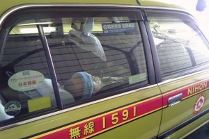 A taxi driver taking a nap in his vehicle - not an uncommon sight.