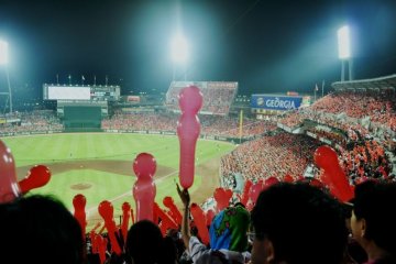 Hiroshima Carp fans blowing balloons before the 7th inning stretch at Mazda &quot;Zoom Zoom&quot; Stadium.