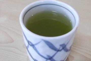 <p>Green tea served in an attractive cup</p>
