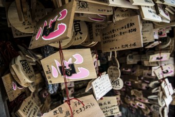 <p>The shrine is literally covered with votive tablets praying for strong relationships and luck in love.</p>
