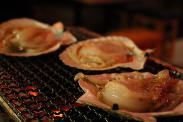 <p>Grilling some clams, served with butter and soy sauce</p>