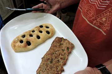 Olive focaccia, and a flat, chewy bread full of sunflower and pumpkin seeds