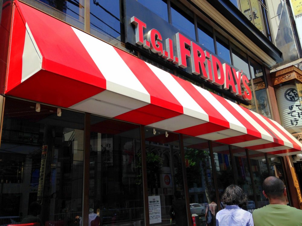 Who could not see the restaurant&#39;s huge name above the red-and-white shade awning?

