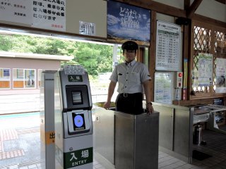 An attendant stands at the ticket gate