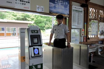 <p>An attendant stands at the ticket gate</p>