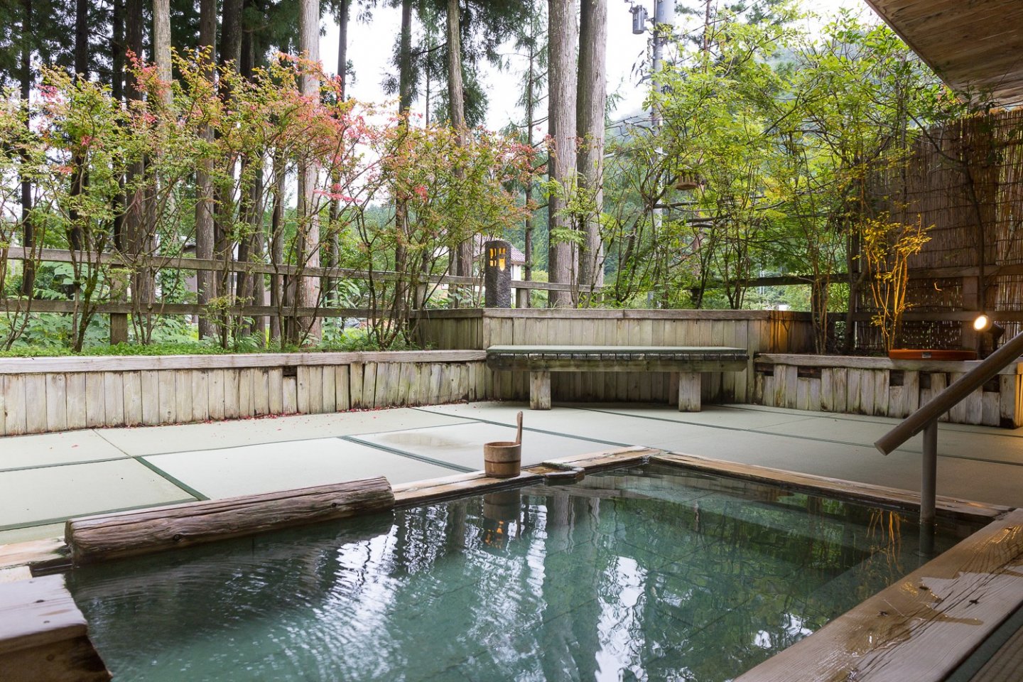 The men's outdoor onsen at the Roan offers a beautiful view of the forest