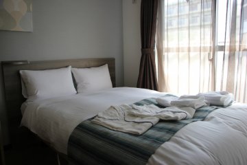 <p>Кровать с полотенцами и халатами</p>