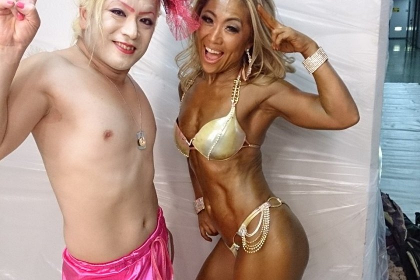Pink Yuji poses with a competitor from the bikini competition