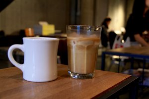 An iced caffe latte and a hot lemonade