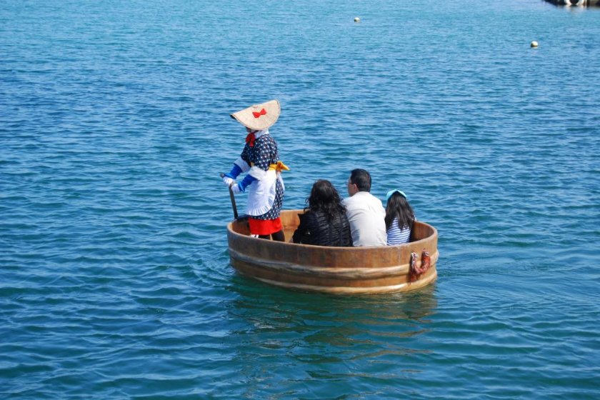 A family taking a tarai bune trip in Ogi Harbor