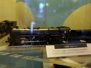 Display of various models of trains from different eras