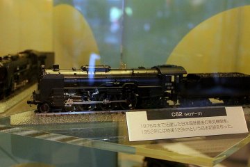 Display of various models of trains from different eras