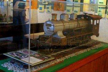 Old train models in a huge glass display case