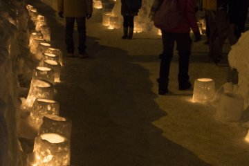 Candlelit path leading to a giant snowman