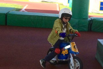 Our six year old at Mobi Park trying out a kids` motorcycle