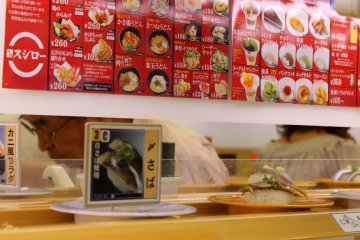 <p>As soon as you take your seats, dishes of sushi pass by your table on the rolling conveyor belt, inviting you to take them...</p>
