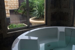 The suite room (16,000 yen from 10pm - 11am), with this gorgeous indoor bath with a giant flat screen tv. Want to experience the patio? There is also a bath on the patio, to the left of the window (Fukushima Prefecture)