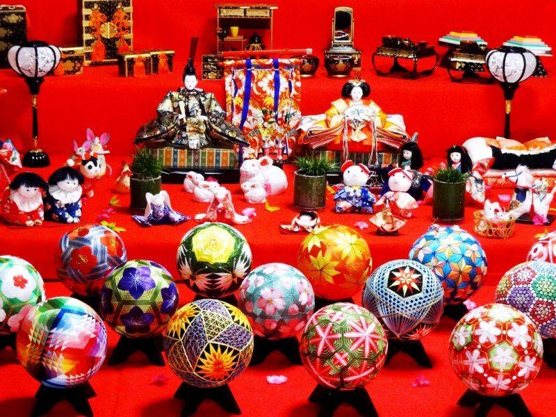 A display of Hina dolls and woven temari 