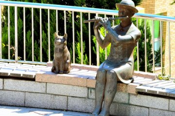 Flute player and cat