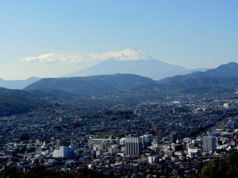 Mt. Fuji rises over the city of Hadano from Mt. Kobo Park