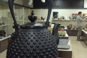 A large iron teapot is located in the gift shop. Similar, though smaller, teapots are made in one of the village's shops.