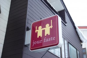 Sign board above the entrance of jour faste
