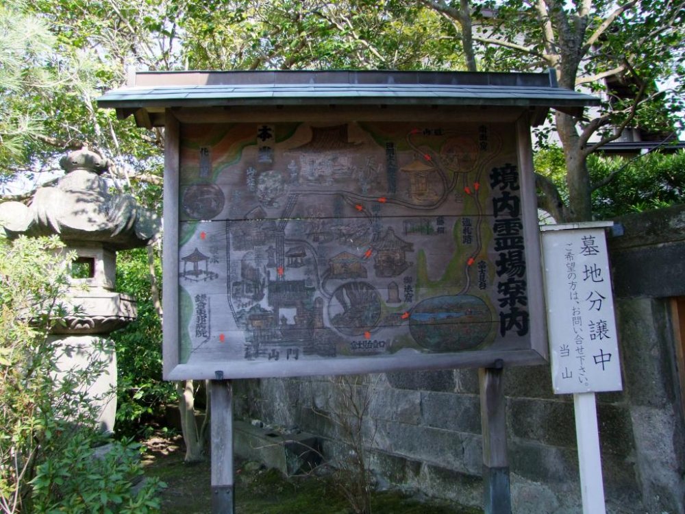 A map of the temple painted on a wood board sign