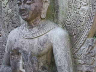 A close up of the Shakamuni Buddha in prayer