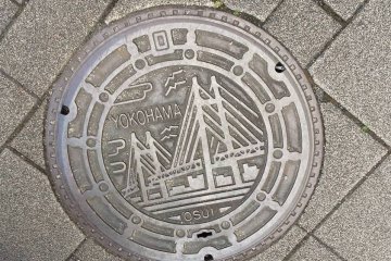 Yokohama's bridge features prominently in the area manhole cover