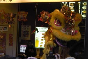 The lion emerges from a Chinatown shop