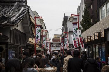 The street leading up to Sanmon, the main gate of Nishiarai Daishi Temple. It is filled with people milling around before the main Setsubun event.