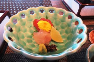 Exquisite Japanese tableware showcasing the sashimi topped with flower