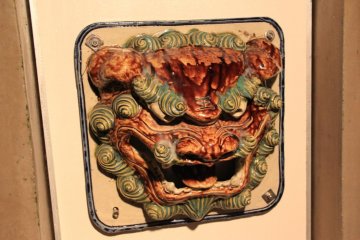 A shisa dog head can be found near entryways throughout Okinawa